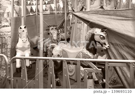 White ponies on an abandoned carousel White ponies on an abandoned carousel 139693110
