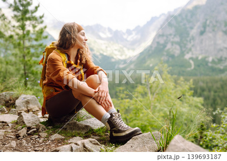 Female legs in hiking boots on hiking trail, on top of mountain outdoors. Nature, relaxation concept Female legs in hiking boots on hiking trail, on top of mountain outdoors. Nature, relaxation concept 139693187
