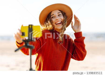Style woman using smartphone with stabilizer. Travel, blogging, technology concept. Style woman using smartphone with stabilizer. Travel, blogging, technology concept. 139693511