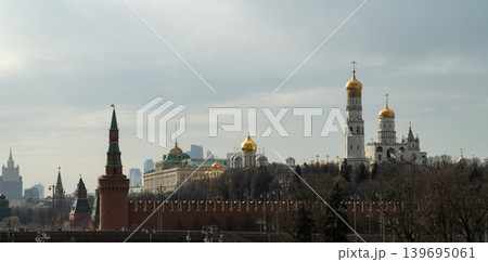 Moscow Kremlin Skyline With Golden Domes and Historic Cathedrals Behind Brick Wall Moscow Kremlin Skyline With Golden Domes and Historic Cathedrals Behind Brick Wall 139695061