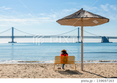 woman on chair at Gwangalli Beach by Gwangan Bridge, Busan 139697163