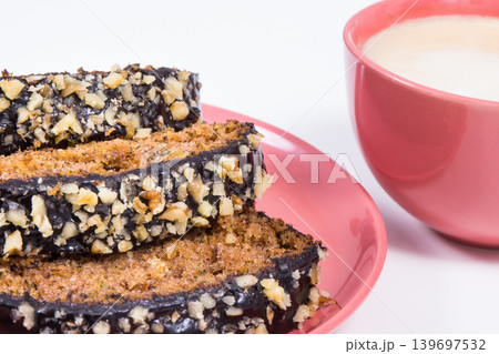 Pastry made of zucchini and cup of white coffee. Delicious dessert. White background Pastry made of zucchini and cup of white coffee. Delicious dessert. White background 139697532
