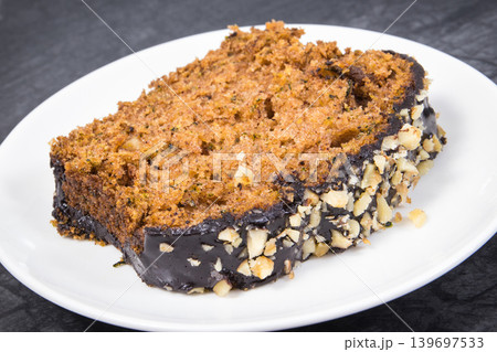 Pastry made of zucchini with nuts and raisin on plate. Delicious dessert 139697533