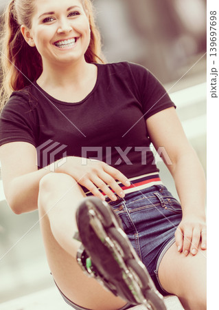 Young woman riding roller skates 139697698