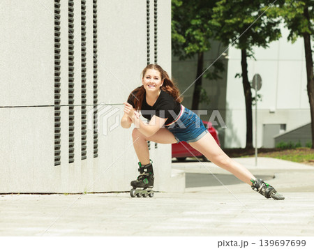 Young woman fast riding roller skates Young woman fast riding roller skates 139697699