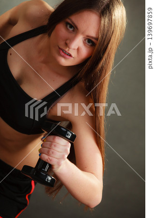 Fit woman exercising with dumbbells. Fit woman exercising with dumbbells. 139697859