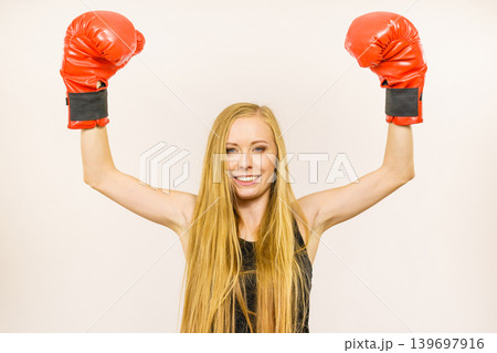 Woman in red gloves with arms up Woman in red gloves with arms up 139697916