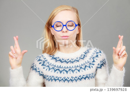 Teenage blonde woman making promise gesture 139697928