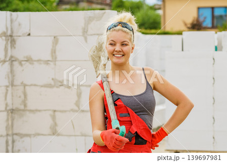 Woman using shovel on constriction site 139697981