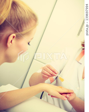 Woman getting hand massage at beauty salon Woman getting hand massage at beauty salon 139697994