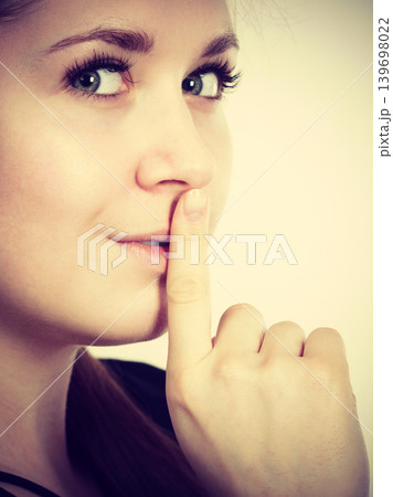 Woman showing silence gesture with finger 139698022