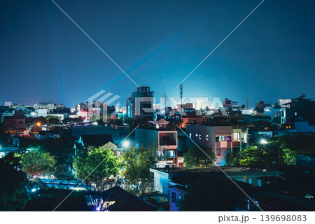 urban night cityscape with glowing residential Da Nang skyline and modern architecture lights, aerial evening view of illuminated city skyline with rooftops and calm atmosphere of Danang, Vietnam 139698083
