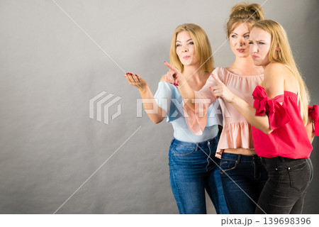 Three fashionable females pointing Three fashionable females pointing 139698396