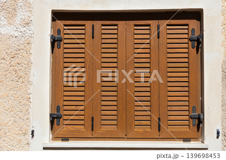 Traditional brown shutters window, Greece Traditional brown shutters window, Greece 139698453