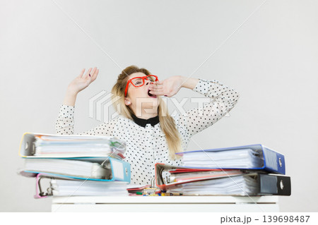 Sleepy business woman in office yawning Sleepy business woman in office yawning 139698487