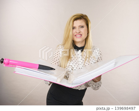 Happy positive business woman holding binder with documents 139698497