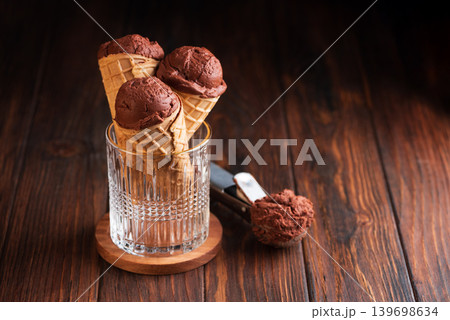 Chocolate Ice Cream Cones on Dark Wooden Background Chocolate Ice Cream Cones on Dark Wooden Background 139698634