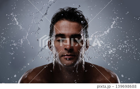 Water splash, liquid and man wash face for bathroom routine, self care or beauty treatment. Eye closed, bathing and model headshot with hygiene, grooming and facial cleanse on dark grey background Water splash, liquid and man wash face for bathroom routine, self care or beauty treatment. Eye closed, bathing and model headshot with hygiene, grooming and facial cleanse on dark grey background 139698688
