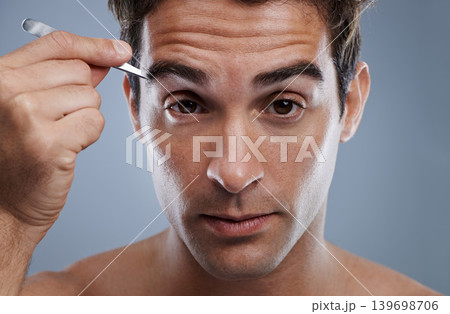 Man, portrait and tweezers for eyebrows or wellness for face grooming, hygiene or grey background. Male person, tools and hair removal for healthy morning routine or studio, treatment or mockup space Man, portrait and tweezers for eyebrows or wellness for face grooming, hygiene or grey background. Male person, tools and hair removal for healthy morning routine or studio, treatment or mockup space 139698706