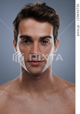 Portrait, skincare and man with cosmetics, wellness and confident guy on grey studio background. Face, person and model with beauty or grooming with routine or dermatology with healthy skin or glow 139698736