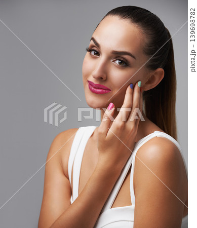 Cosmetics, manicure color and portrait of woman with studio makeup, beauty care or creativity in hand paint design. Nail salon, fresh treatment and spa girl with grooming routine on grey background Cosmetics, manicure color and portrait of woman with studio makeup, beauty care or creativity in hand paint design. Nail salon, fresh treatment and spa girl with grooming routine on grey background 139698782
