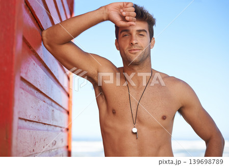 Happy man, portrait and lifeguard on beach for security, bay watch or outdoor swimming in health and safety. Face of male person or professional swimmer smile in fitness for patrol at sea or ocean 139698789