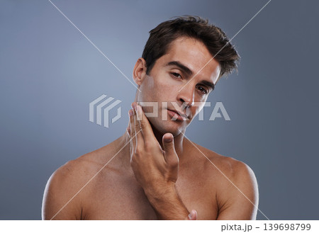 Portrait, glow and man with skincare, shaving and dermatology on grey studio background. Face, person and model with grooming routine and healthy skin with treatment, cosmetics and smooth with shine Portrait, glow and man with skincare, shaving and dermatology on grey studio background. Face, person and model with grooming routine and healthy skin with treatment, cosmetics and smooth with shine 139698799