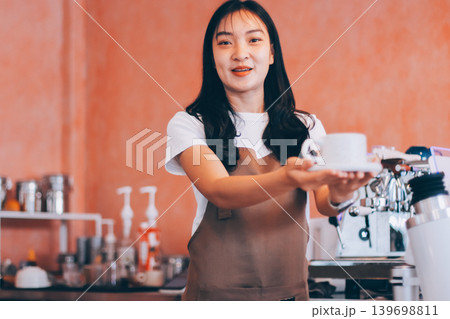 Young woman at barista school learning how to make espresso coffee. 139698811