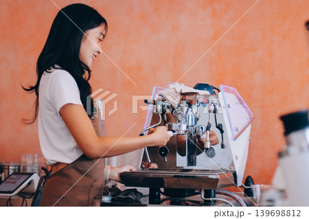 Young woman at barista school learning how to make espresso coffee. 139698812