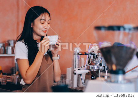 Young woman at barista school learning how to make espresso coffee. Young woman at barista school learning how to make espresso coffee. 139698818