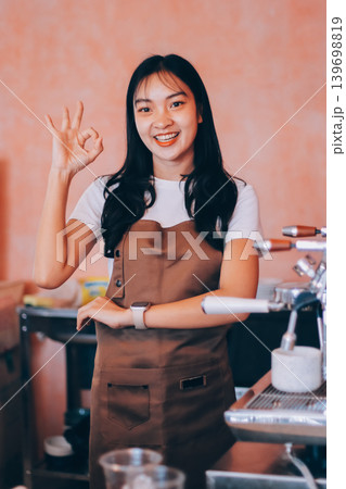 Young woman at barista school learning how to make espresso coffee. Young woman at barista school learning how to make espresso coffee. 139698819