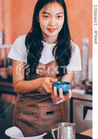 Young woman at barista school learning how to make espresso coffee. Young woman at barista school learning how to make espresso coffee. 139698821