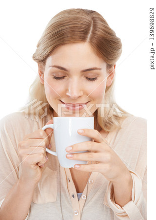 Relax, smile and woman with coffee in studio for break, aroma or peaceful moment on white background. Tea, face and happy female model with hot drink for comfort, scent or caffeine satisfaction Relax, smile and woman with coffee in studio for break, aroma or peaceful moment on white background. Tea, face and happy female model with hot drink for comfort, scent or caffeine satisfaction 139698829