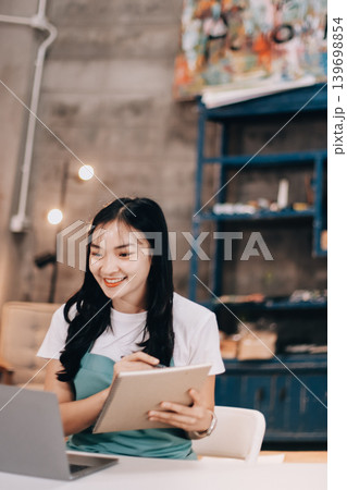 Female artist wears black hat posing near picture indoor the studio 139698854