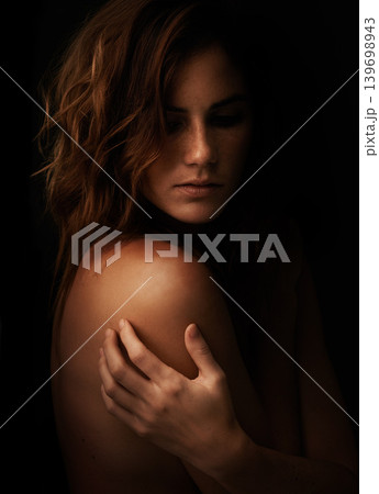 Woman, body and skincare in studio for beauty, dermatology and shadow or light for art deco and aesthetic. Cosmetics model or serious person with self care and creative on a dark or black background Woman, body and skincare in studio for beauty, dermatology and shadow or light for art deco and aesthetic. Cosmetics model or serious person with self care and creative on a dark or black background 139698943