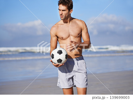 Man, beach and soccer ball for game, sports or exercise in outdoor hobby for training or practice. Young male person or football player on ocean coast for match or cardio workout by the seaside Man, beach and soccer ball for game, sports or exercise in outdoor hobby for training or practice. Young male person or football player on ocean coast for match or cardio workout by the seaside 139699003