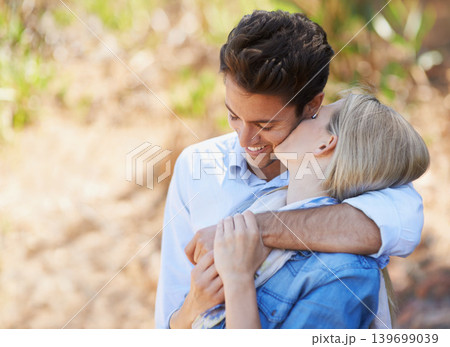 Happy couple, kiss and hug in nature for bonding, love or support in relax for outdoor affection. Face of young woman and man with smile for embrace, comfort or romance in forest or woods together Happy couple, kiss and hug in nature for bonding, love or support in relax for outdoor affection. Face of young woman and man with smile for embrace, comfort or romance in forest or woods together 139699039