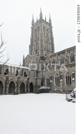 Bryn Athyn Cathedral stone tower and cloisters courtyard during winter snow. 139699064