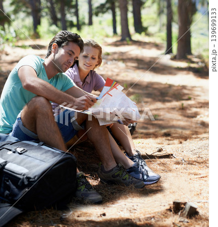 Couple, travel in forest and reading map for direction, documents guide or location information on a journey. Lost people on a break with infographics, brochure of nature and destination for trekking Couple, travel in forest and reading map for direction, documents guide or location information on a journey. Lost people on a break with infographics, brochure of nature and destination for trekking 139699133
