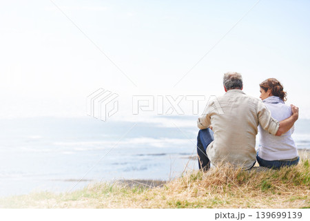 Couple, hug and travel by the beach with love on holiday, vacation or marriage with mockup space. Summer, nature and man embrace woman with support, care and trust with landscape of sea and ocean 139699139