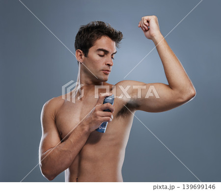 Man, deodorant and spray for armpit or smell in studio or product application for clean odor, hygiene or grey background. Male person, topless and confidence or health wellness, care or mockup space Man, deodorant and spray for armpit or smell in studio or product application for clean odor, hygiene or grey background. Male person, topless and confidence or health wellness, care or mockup space 139699146