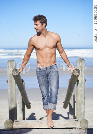 Walk, shirtless and young man at the beach on tropical vacation, adventure or holiday. Travel, stairs and confident male person on outdoor steps by the ocean, coast or sea for summer weekend trip. 139699189
