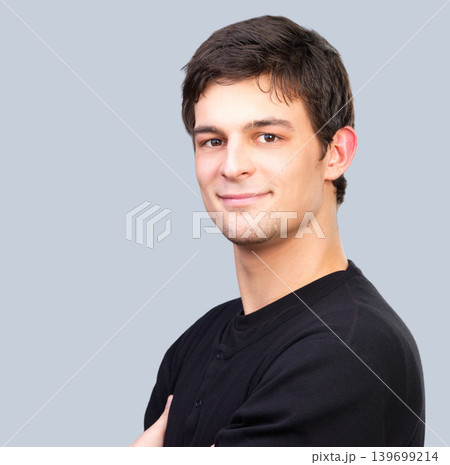 Portrait, smile and confident young man in studio on gray background with space for casual fashion. Face, happy and friendly with natural model on mockup in relaxed tshirt or clothes outfit for style Portrait, smile and confident young man in studio on gray background with space for casual fashion. Face, happy and friendly with natural model on mockup in relaxed tshirt or clothes outfit for style 139699214