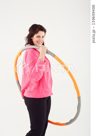 Happy woman, portrait and hoop for fitness, exercise or workout in balance on a white studio background. Active female person smile with plastic circle for training, practice or health and wellness 139699486