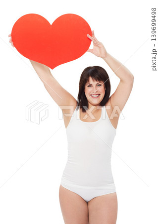 Portrait, heart and happy plus size woman in studio isolated on a white background. Love, sign or symbol of model in underwear with healthy body for care, kindness emoji and romance on valentines day 139699498