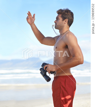 Man, binoculars and lifeguard on beach with whistle in security, emergency or health and safety. Young male person monitoring, bay watch or patrol by the ocean coast or sea in surveillance or danger Man, binoculars and lifeguard on beach with whistle in security, emergency or health and safety. Young male person monitoring, bay watch or patrol by the ocean coast or sea in surveillance or danger 139699532