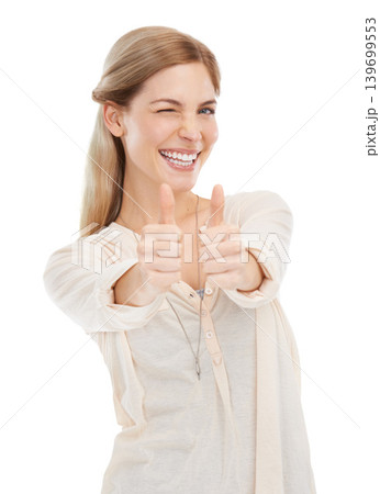 Portrait, wink and happy woman with thumbs up in studio for support, trust or winning gesture on white background. Face, smile and female model with hand emoji for success, thank you or motivation Portrait, wink and happy woman with thumbs up in studio for support, trust or winning gesture on white background. Face, smile and female model with hand emoji for success, thank you or motivation 139699553