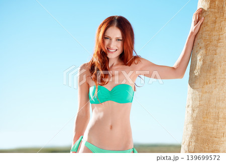 Portrait, smile and woman in bikini on tropical vacation or luxury holiday at hotel with blue sky. Travel, summer and palm tree with happy young person outdoor to relax in swimwear on island getaway Portrait, smile and woman in bikini on tropical vacation or luxury holiday at hotel with blue sky. Travel, summer and palm tree with happy young person outdoor to relax in swimwear on island getaway 139699572
