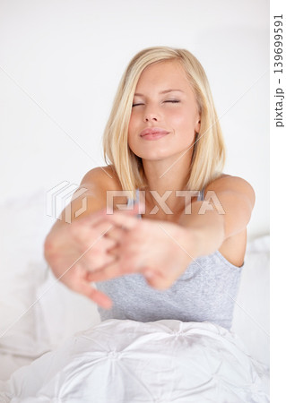 Woman, wake up and stretching on bed in morning with peace and wellness in home. Calm, girl and relax in bedroom on holiday or vacation with healthy routine and self care in house or apartment Woman, wake up and stretching on bed in morning with peace and wellness in home. Calm, girl and relax in bedroom on holiday or vacation with healthy routine and self care in house or apartment 139699591