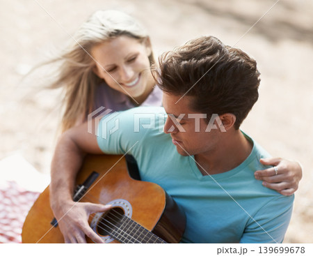 Couple, picnic and playing guitar for romance, love or song in outdoor bonding, fun or relaxing together in nature. Man and woman smile with instrument for acoustic sound, strumming or music outside Couple, picnic and playing guitar for romance, love or song in outdoor bonding, fun or relaxing together in nature. Man and woman smile with instrument for acoustic sound, strumming or music outside 139699678